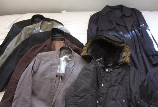 organize jackets and coats on bed