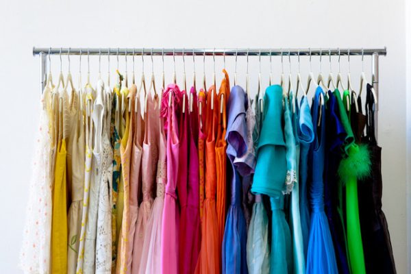 rolling clothes rack hanging color-coded shirts