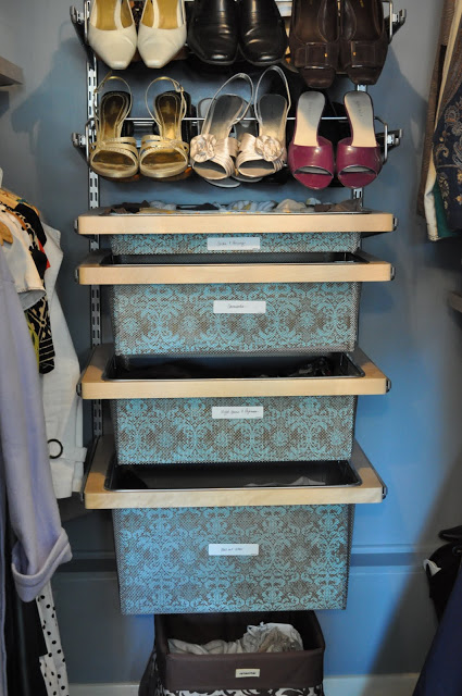 organized master closet with shoe racks and pull-out storage bins