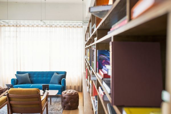 wall bookshelves, ottoman, coffee table, sofa, and chair