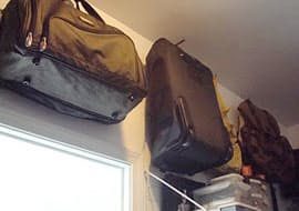 hang suitcase, duffel bag, and luggage on wall hooks