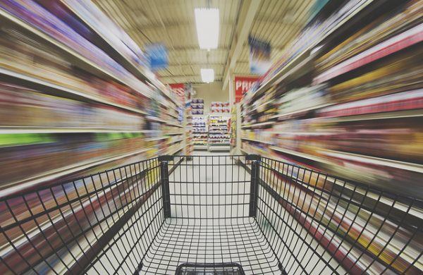 moving shopping cart in a grocery store aisle