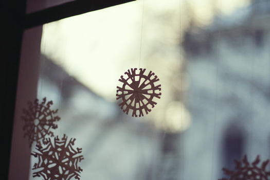 stick paper snowflakes on windows