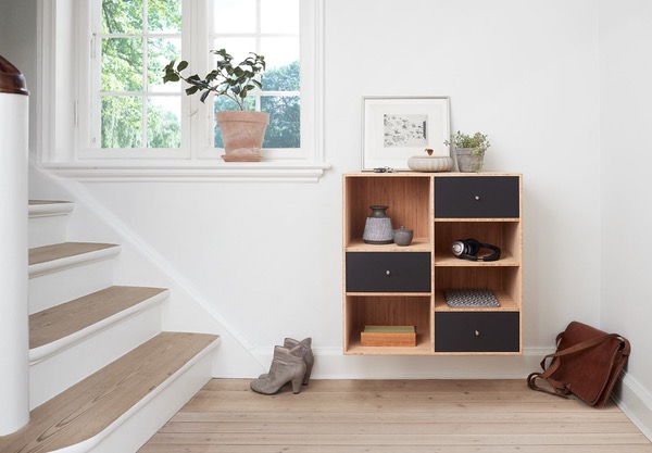 organized entryway with wall cubes storing headphones, and boots and a messenger bag on the floor