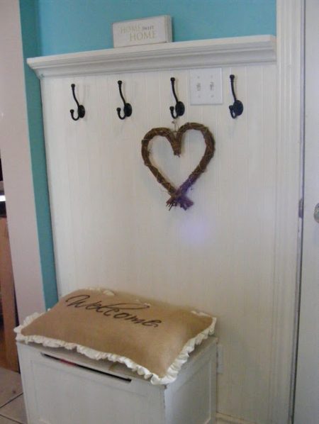 white entry bench with storage and hooks