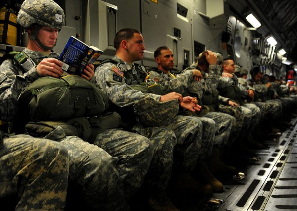 soldiers sitting in a row and reading books