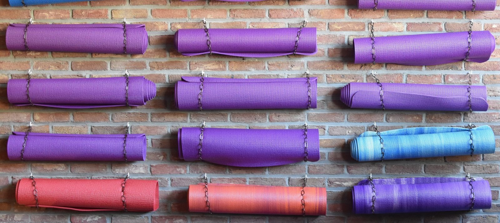 yoga mat storage on a brick wall