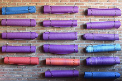 yoga mat storage on a brick wall