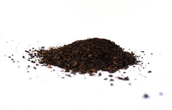 ground coffee beans on a clean white surface