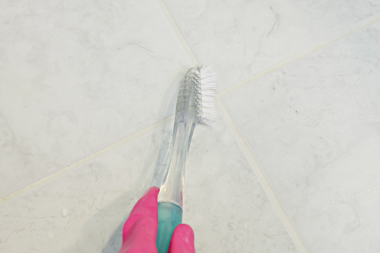 cleaning grout with toothbrush by iheart organizing