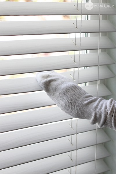 cleaning blinds with sock, vinegar, and water