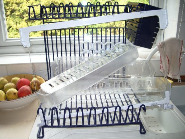 clean fridge shelves on a drying rack