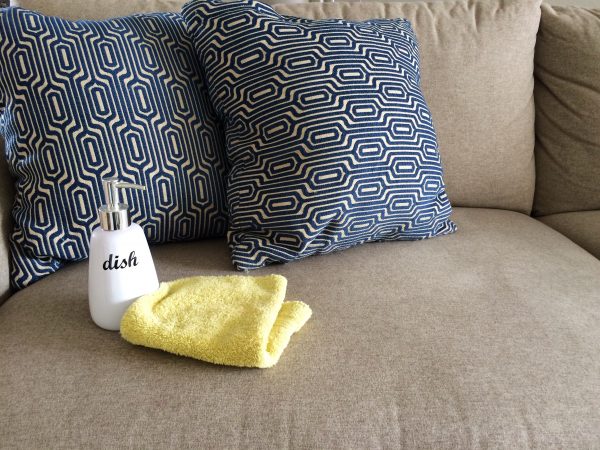 how to remove stains from a fabric sofa: squirt dish soap on it, let it sit for several minutes, and wipe it off with a clean wet cloth