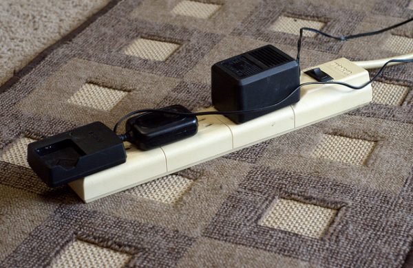 power strip with three chargers plugged in