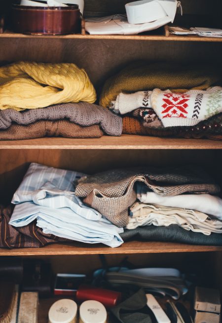 clothing and accessories on closet shelves