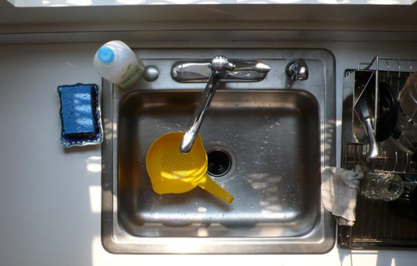 yellow strainer in a kitchen sink