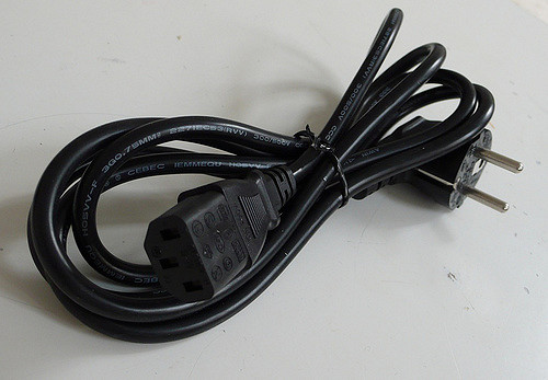 black power cord wrapped with a black plastic tie