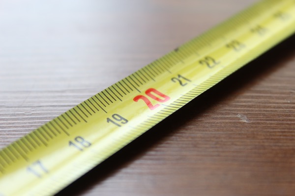 closeup of a tape measure on a wooden surface