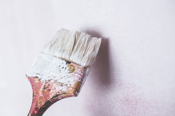 paint brush painting a wall white