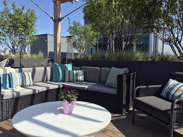 brianne bishop's luxe on chicago rooftop project includes an outdoor sectional, chair, and coffee table