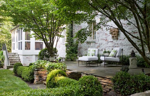 backyard patio with 2 outdoor chairs with cushions and throw pillows, designed by kelley proxmire