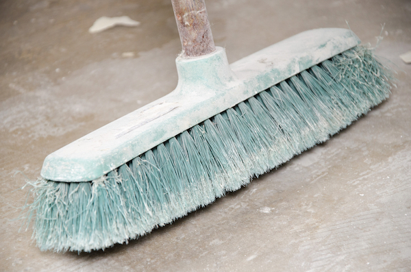 A dusty broom for sweeping the garage.