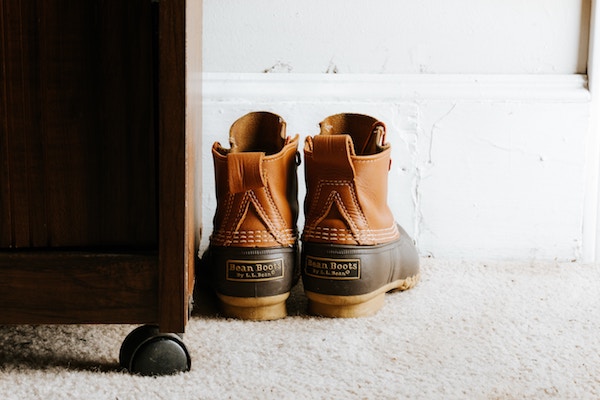 A pair of boots is set next to an entrance console.