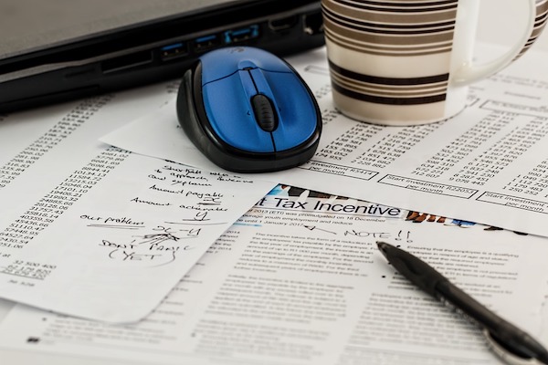 cluttered papers and a mouse
