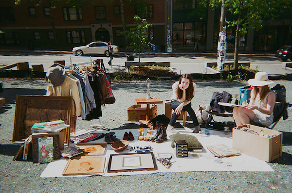 a woman looks overwhelmed by her yard sale