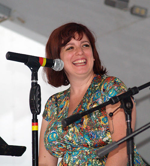 A photo of Sara Benincasa at a microphone