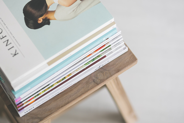 a pile of magazines on a coffee table