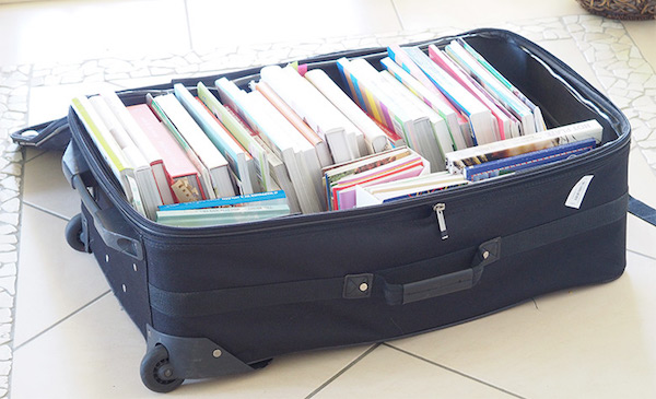 a collection of books inside a suitcase