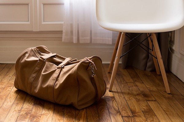 An overnight bag next to a chair