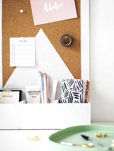 A closeup of a DIY cork board desk organizer