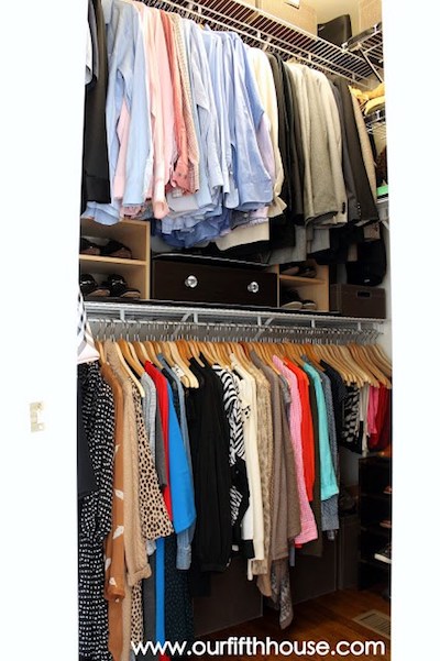 hanging clothes in an organized closet