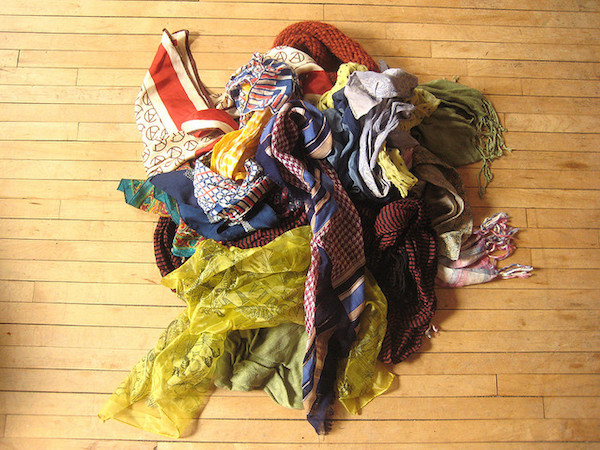 A collection of chic women's scarves on a wooden floor 