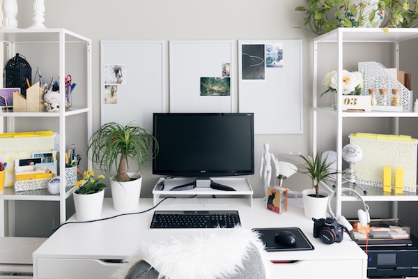 a big open desk with shelves on each side and plenty of tools and resources