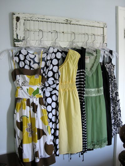 7 dresses hanging on a wall-mounted storage rod