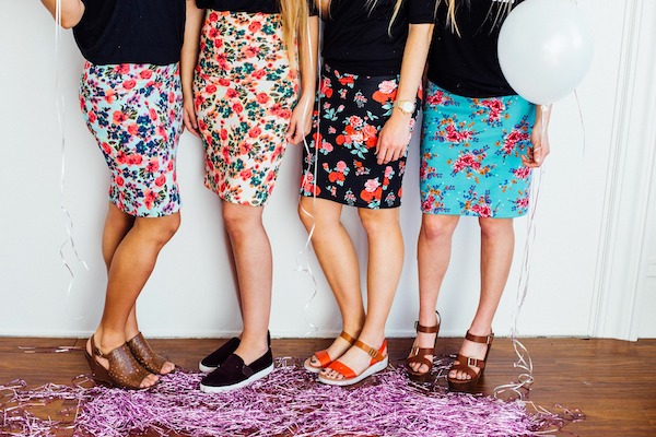 4 girls in floral skirts and black tops