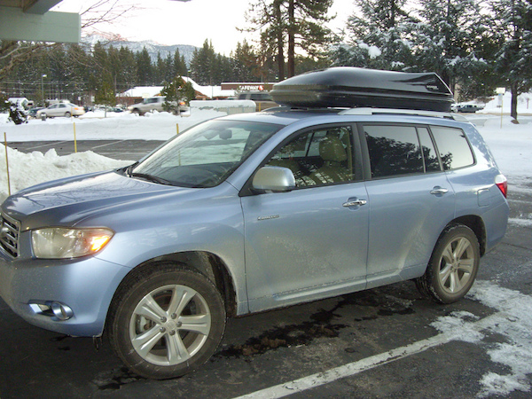 an SUV with a rooftop carrier during winter