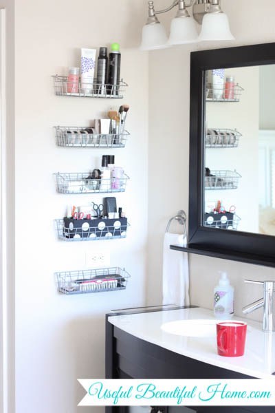5 wire baskets mounted vertically on a white bathroom wall