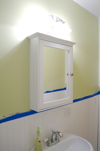 a white and wall-mounted DIY medicine cabinet with a mirror
