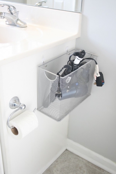 a file box hot tools organizer mounted on the side of a bathroom sink cabinet