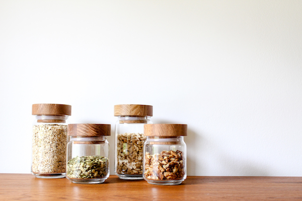 4 glass jars on a flat table decanting pantry staples