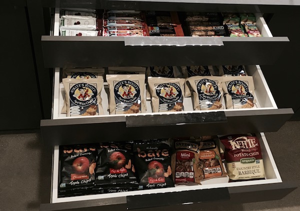 savory snack items like Pirates Booty, kind bars, and kettle potato chips are organized in pullout shelves