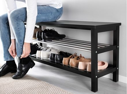 a black TJUSIG Bench with Shoe Storage from Ikea