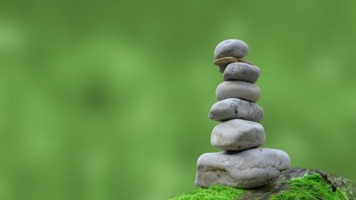 zen rocks stacked to increase positive energy and peace
