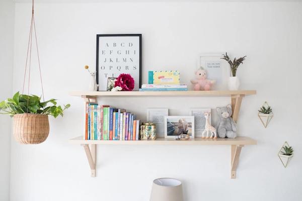 a white nursery with a pair of floating shelves