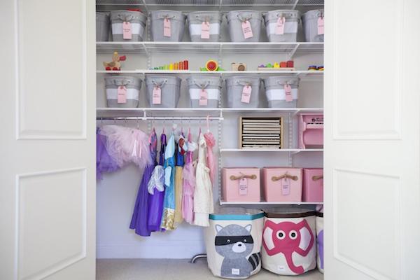 shelves in a play room hold bins of toys and play gear