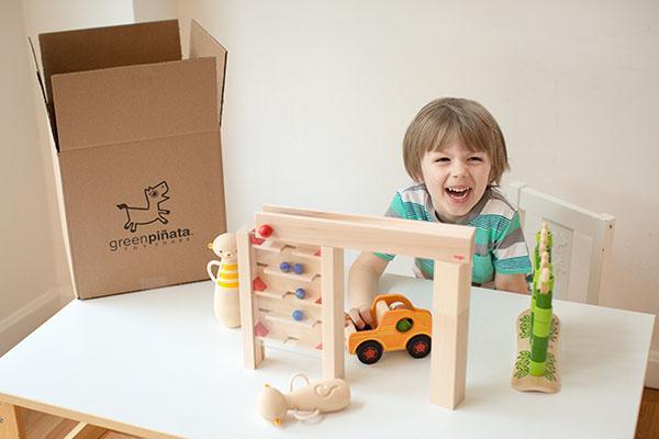 a little boy is excited to have received his Green Piñata box